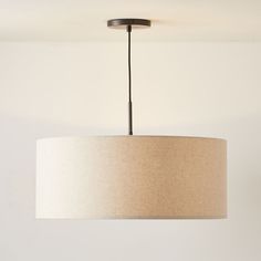 a light fixture hanging from the ceiling in a room with white walls and flooring