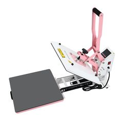 a pink and white machine sitting on top of a tabletop next to a gray pad