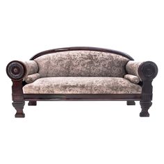 an old fashioned couch with ornate carvings on the armrests and foot rests against a white background