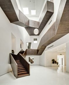 the interior of a modern house with stairs and skylights