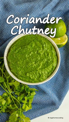 a white bowl filled with green salsa next to cilantro