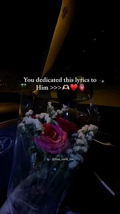 a car dashboard with flowers and a message written on the front window that says, you dedicated this type of love to him