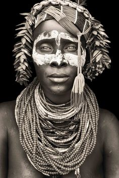 an african woman with painted face and headdress