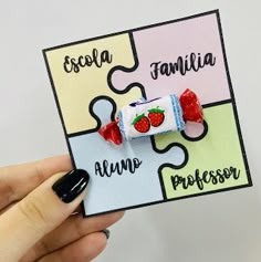 a person holding up a piece of puzzle with strawberries on it and the word familla in spanish