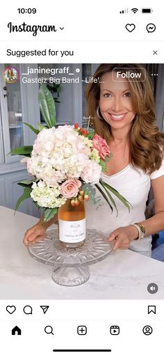 a woman holding a bouquet of flowers on top of a table with the caption instagram