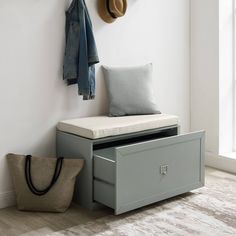 a bench with a coat rack and hat hanging on it's wall next to a bag