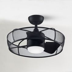 a black ceiling fan with a white light on it's side and an air vent in the middle