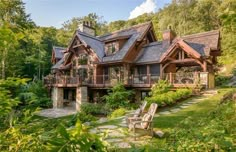 a wooden house surrounded by lush green trees