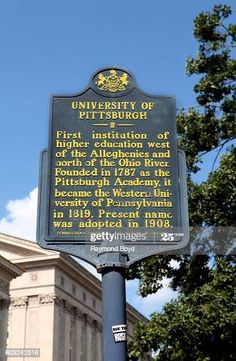 the university of pittsburgh sign in front of an old building on a sunny day stock photo