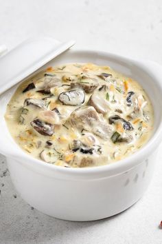 a white bowl filled with food on top of a table