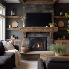 a living room filled with furniture and a fire place under a flat screen tv mounted on a wall