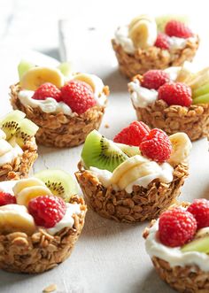 some fruit and yogurt cups are sitting on a table