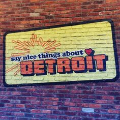 a sign on the side of a building that says, say nice things about detroit