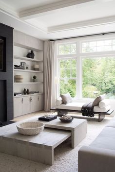 a living room filled with furniture and a flat screen tv mounted on a wall next to a fire place