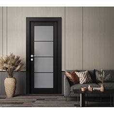 a living room with a gray couch and black door