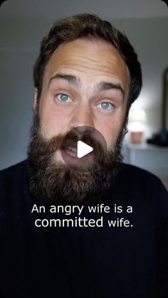 a man with a beard and blue eyes is making a funny face at the camera