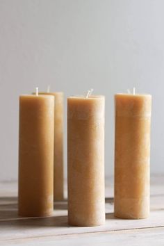 three candles sitting next to each other on a table