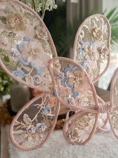 an arrangement of flowers and butterflies on a table