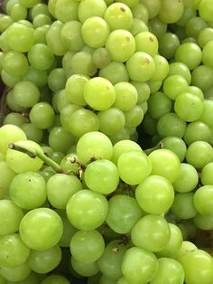 bunches of green grapes sitting on top of each other