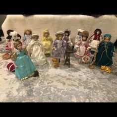 a group of dolls sitting next to each other on a table