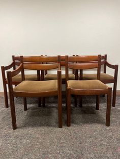 a set of four dining chairs with padded seats