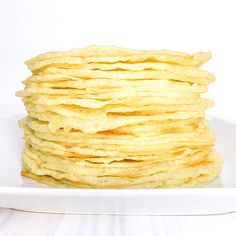 a white plate topped with pancakes on top of a table