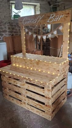 a pallet bar made out of wood with lights on the top and bottom part