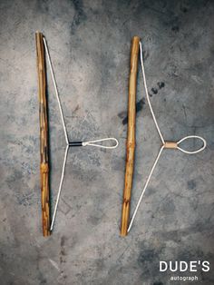 two pairs of knitting needles sitting next to each other on top of a gray surface