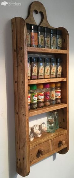 an old wooden spice rack with jars and spices on it's sides, hanging from the wall