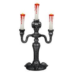 three candles are lit with blood dripping down from them and on the top of each candle holder