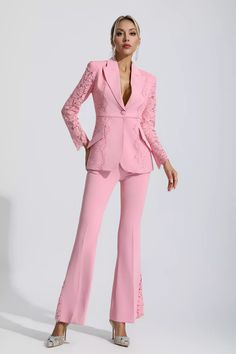 a woman in a pink suit posing for the camera