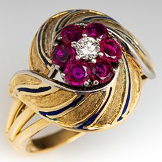 This elegant circa 1940s features engraved details with blue enameling. The ring is centered with one (1), prong set, round brilliant cut diamond, bordered with six (6), prong set, round mixed cut natural rubies. The ring measures 17.8mm at the top, rises 9.6mm above the finger, tapering to 2.3mm wide and 1.1mm thick at the base of the shank. This ring is currently a size 10. Vintage Ruby Rings, Ruby Wedding Rings, Ruby Rings, Diamond Cocktail Ring, Ruby Engagement Ring, Diamond Cocktail Rings, July Birthstone, Ruby Diamond, Pretty Rings