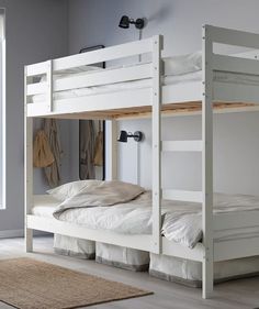 a bunk bed with two sets of mattresses