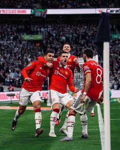 the soccer players are celebrating on the field