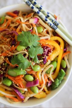 a white bowl filled with vegetables and noodles