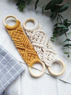 two crocheted objects sitting next to each other on top of a white table