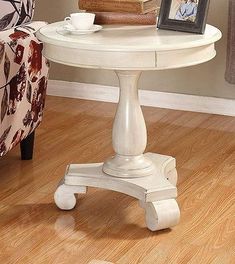 a white table sitting on top of a hard wood floor