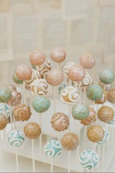 some cake pops that are on top of a white stand with the words how to make perfect cake pops