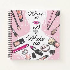 a spiral notebook with makeup and make - up illustrations on the cover, sitting on a white surface