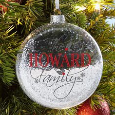 a glass ornament hanging from a christmas tree with the words how are family written on it