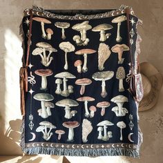 a tapestry with mushrooms on it hanging from a wall