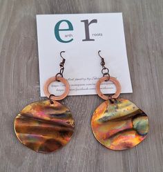 These boho style earrings feature 1.5" copper blanks that have been fire painted with a propane torch to bring out the different colors in the metal when heated. NOTE:  Certain types of lighting will bring the colors out more than other types of lighting. They are finished with a smaller copper hoop.  They measure just under 3" in length. They will ship in a gift box via USPS with tracking info provided,. Artsy Hand Painted Copper Jewelry, Artsy Nickel-free Copper Earrings, Artsy Brown Copper Jewelry, Artistic Copper Earrings With Patina, Hand Painted Copper Bohemian Earrings, Bohemian Hand Painted Copper Earrings, Handmade Rust Copper Earrings, Hand Painted Copper Artsy Earrings, Artisan Orange Copper Earrings