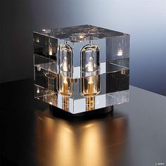 a clear box with two lights inside on a table