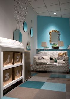 a living room filled with furniture and decor on top of a blue carpeted floor