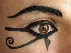 a woman's eye with black and white designs on her face, as if for the eyeshadp