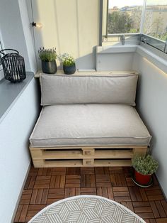 a couch made out of wooden pallets on a balcony