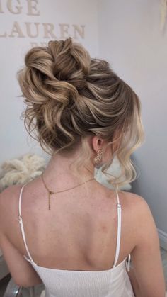 a woman with blonde hair in a low bun