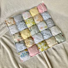 a quilted blanket with many different colored squares