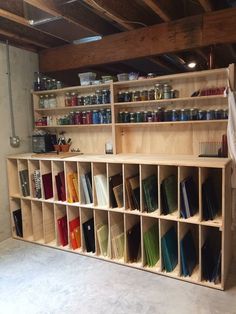 a room with shelves filled with books and cans on the wall next to each other