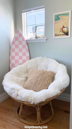 a dog bed in the corner of a room with a surfboard on the wall